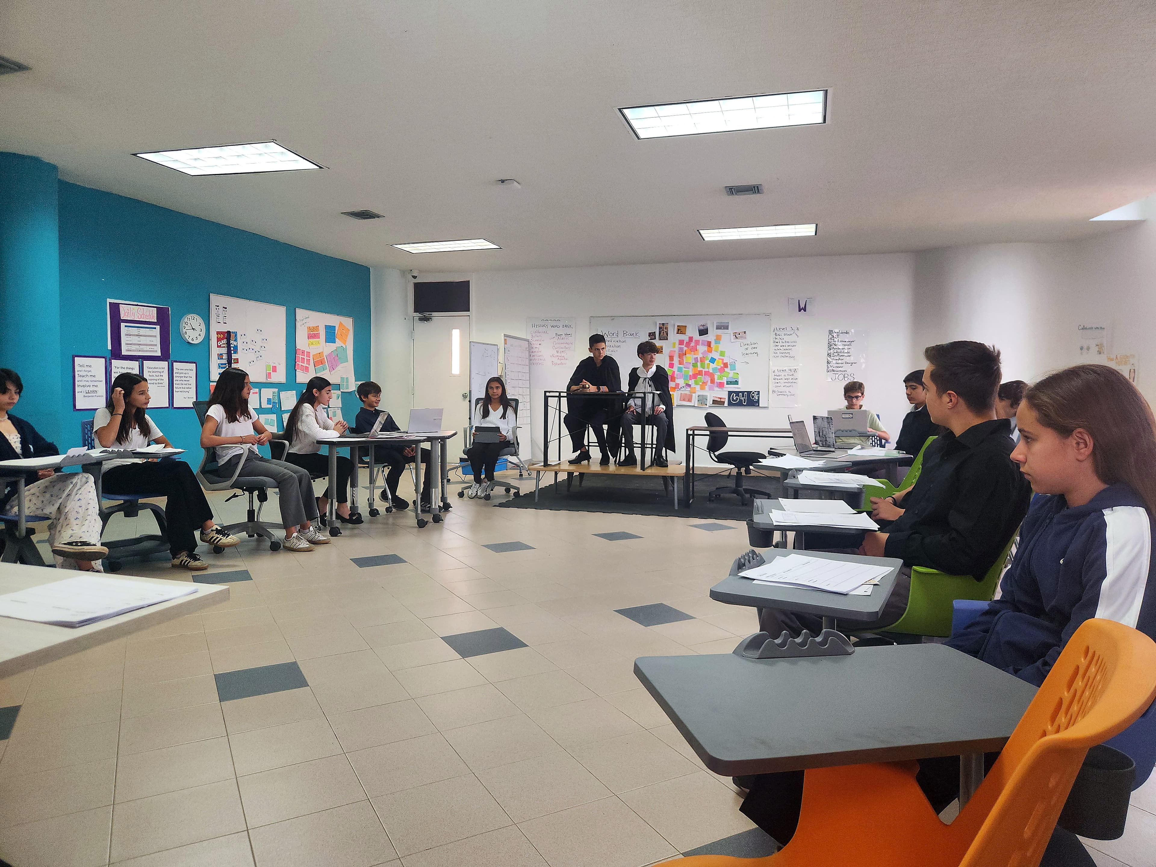 Mentor guiding students through a learning moment