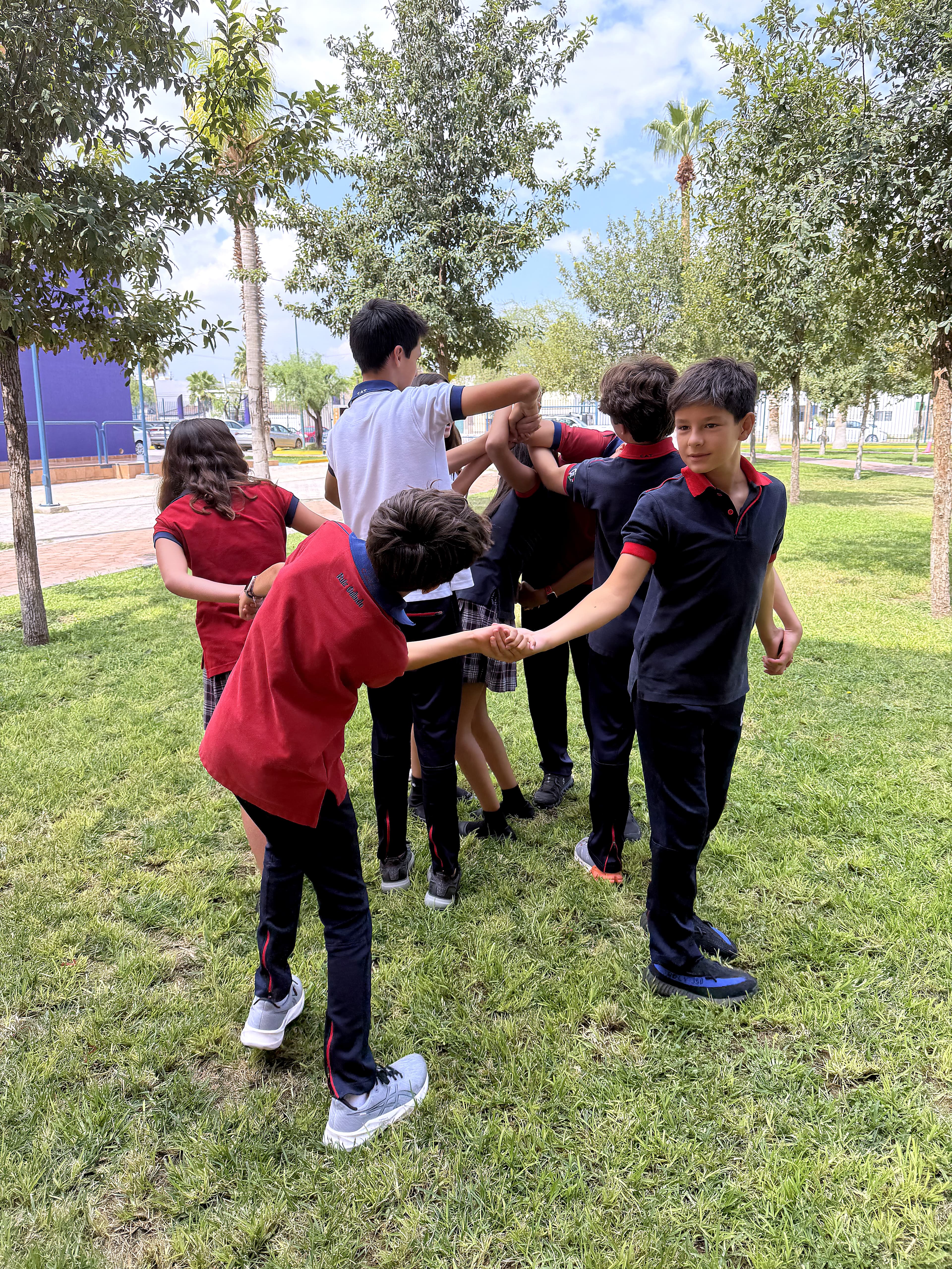 Quantum students collaborating outdoors in a circle