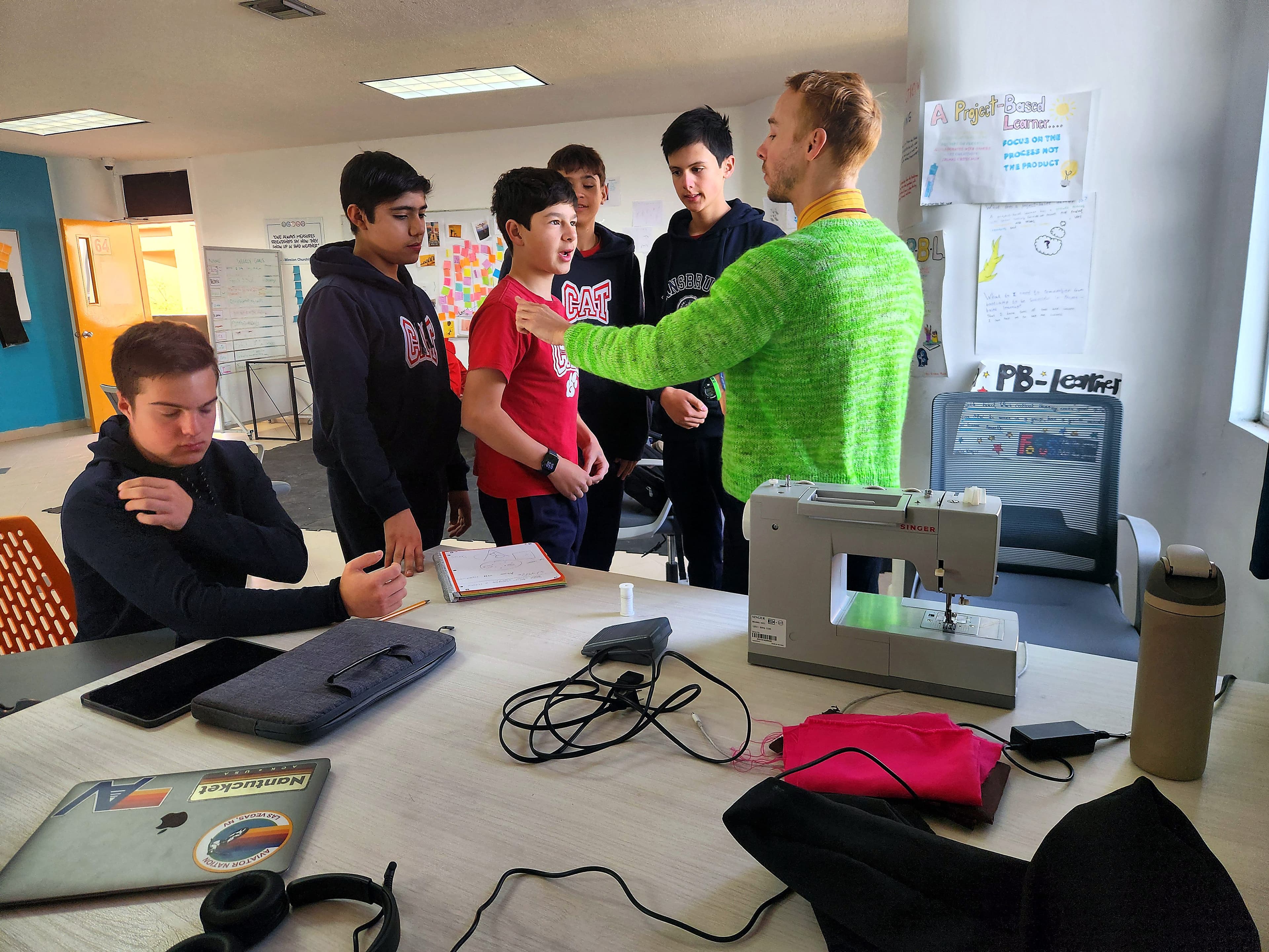 Quantum students and mentor gathered around a project table