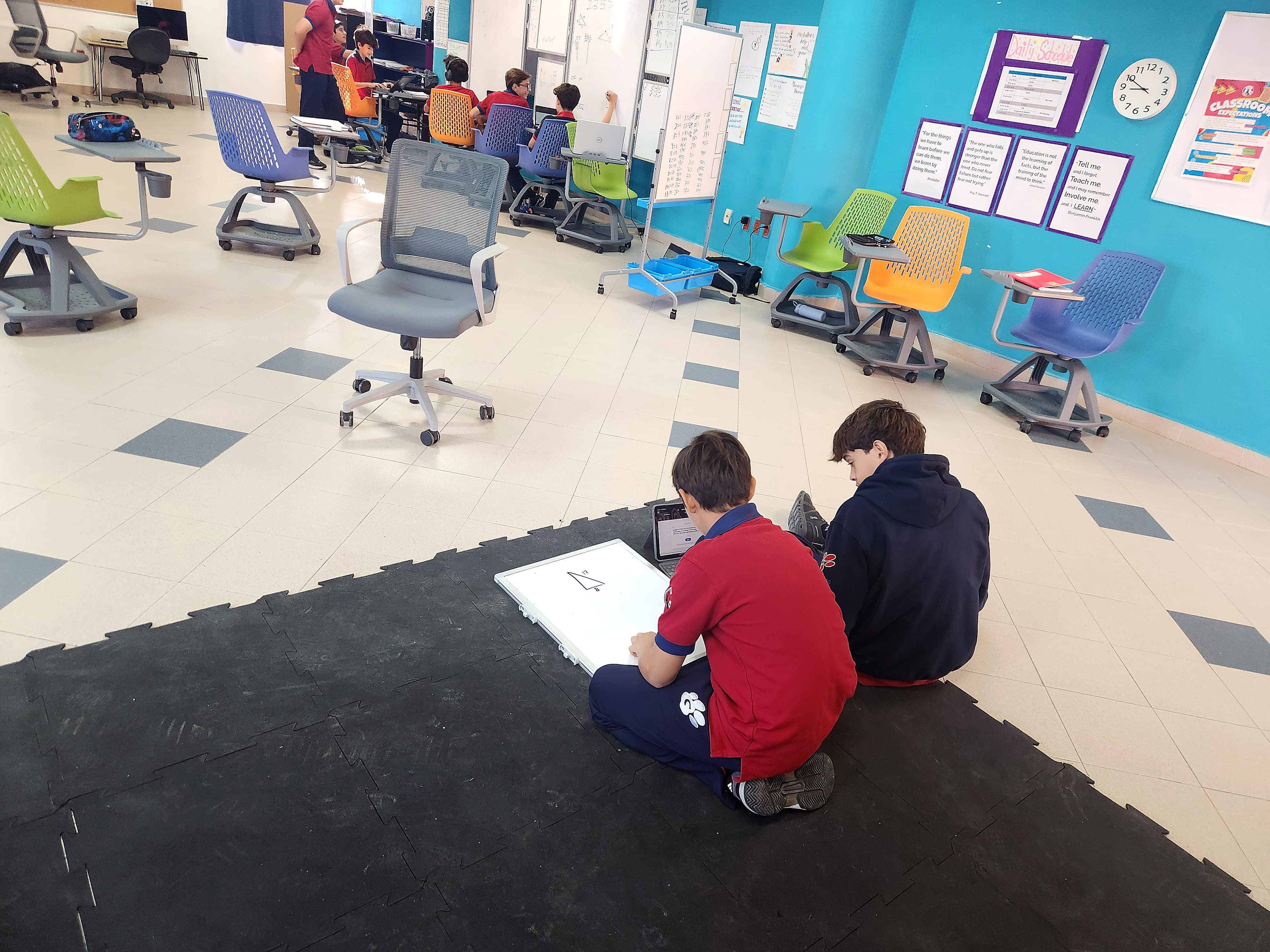 Students working at a table with learning materials